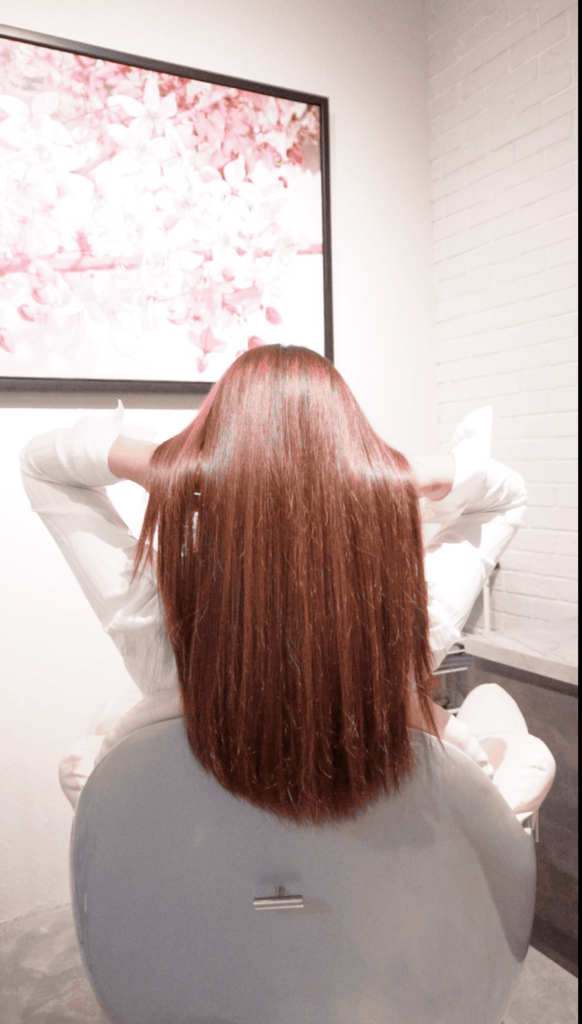 Client with shiny hair after a revitalizing scalp treatment at Siesta Head Spa