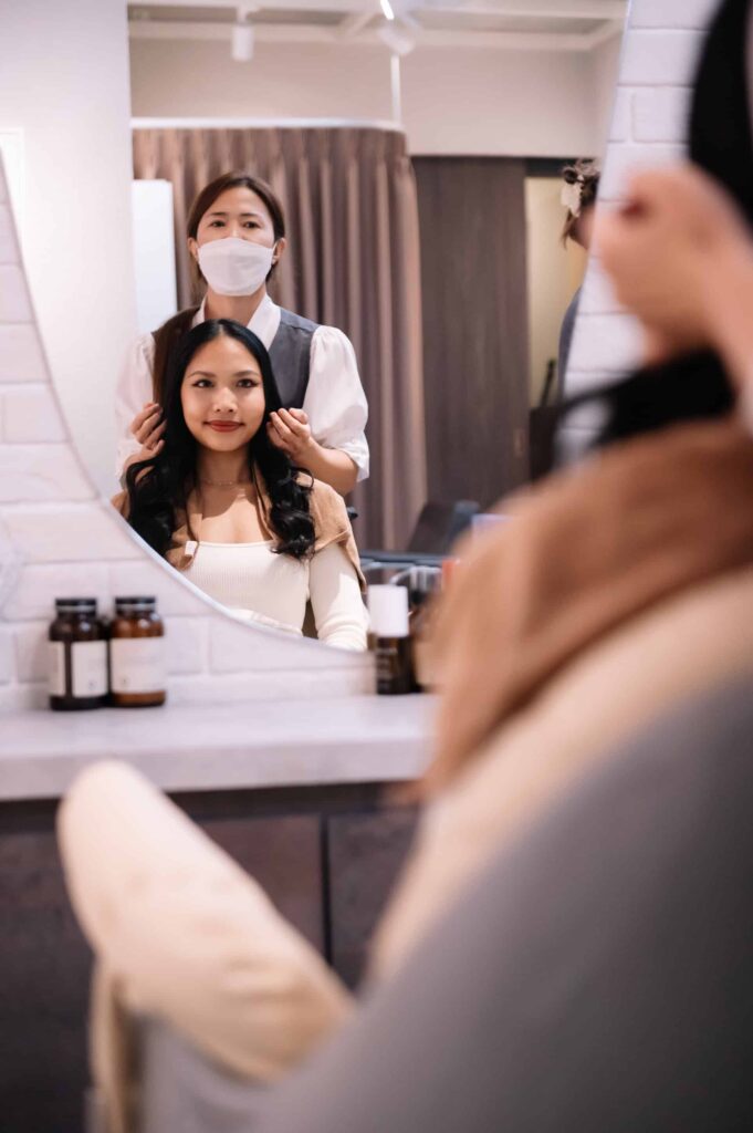 Therapist and client smiling after a relaxing scalp treatment to reduce stress