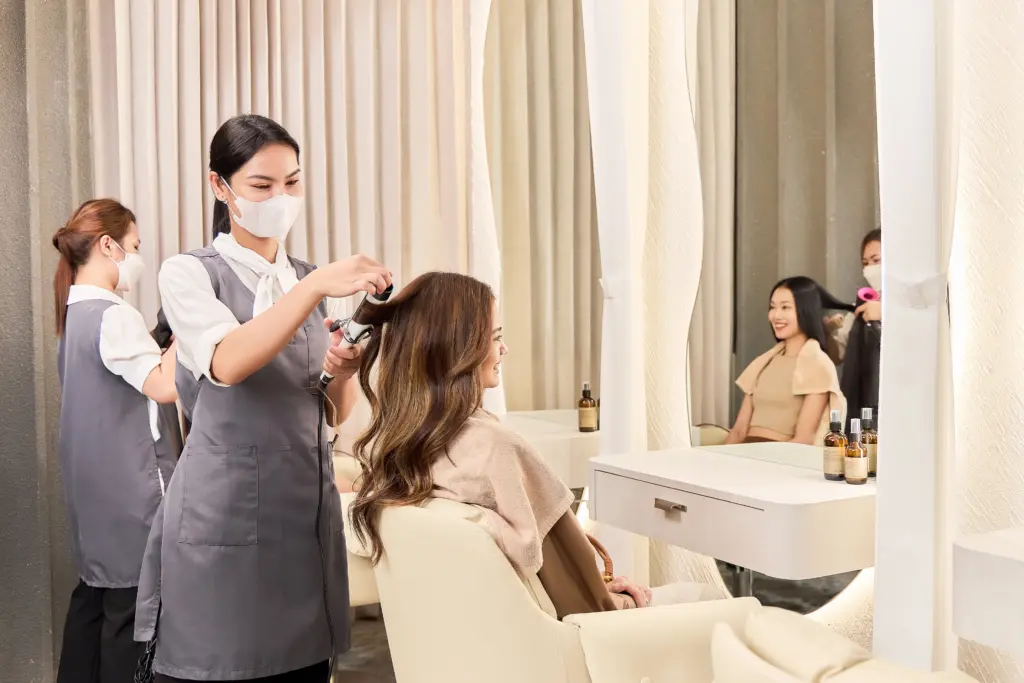 Siesta Head Spa therapist providing a relaxing head spa treatment for a guest in a calm and private Bangkok salon setting