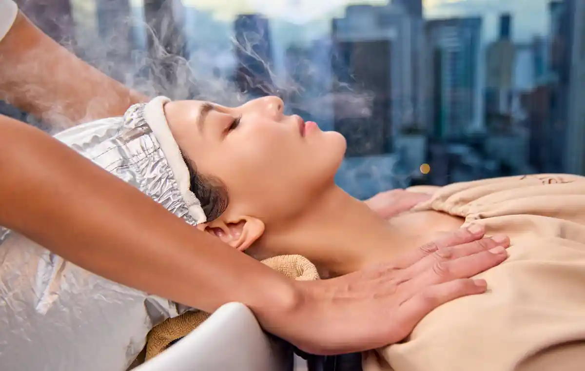 Therapist performing Deep Scalp Detox Treatment during the Signature Scalp program.
